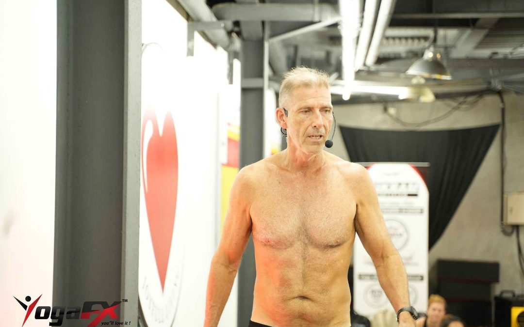 Mr. Ian Terry teaching a heated 26 and 2 class by voice, showing yoga for men over 50 led by an experienced instructor